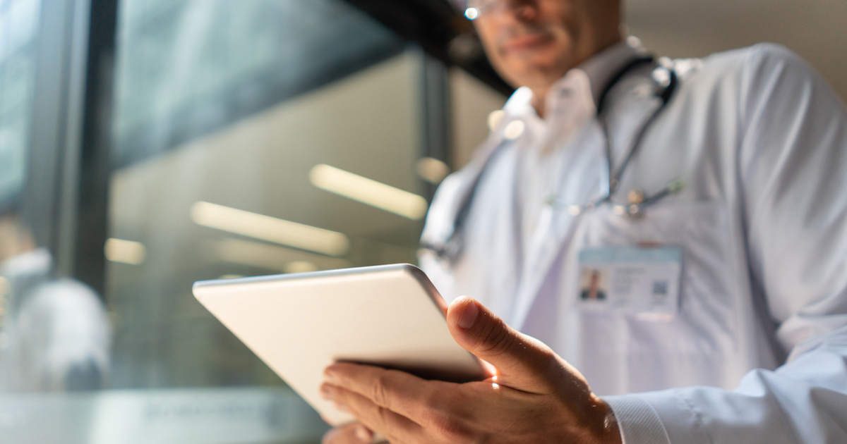 Healthcare provider looking at a tablet