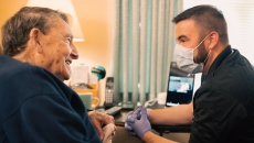 
  An Atrium Health community paramedic consults with patient in his home.
