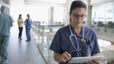 
  Healthcare professional looking at a tablet
