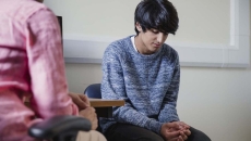 
  Two people sitting in a room 

