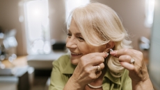 Person putting in a hearing aid