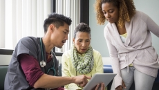 Healthcare professional two people looking at data on a tablet