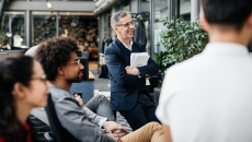 Employees sitting around and looking at something