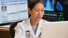 
  Healthcare provider sitting at a computer
