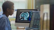 Person looking at computer monitors