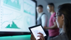 
  A group of researchers analysing graphs
