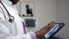 
  Healthcare provider looking at x-ray images on a tablet
