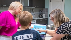 Professor Sonja March of USQ demonstrating the use of Momentum to a parent and child