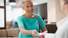 
  Person handing a piece of paper to a healthcare professional
