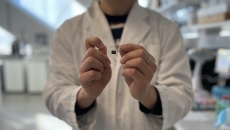 
  A researcher showing a wearable skin patch for remote health monitoring

