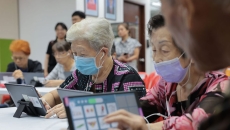 
  Seniors at Lions Befrienders playing the AMI app on their tablets

