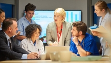 
  Businesspeople and doctors in a meeting together.
