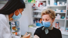 
  A person getting a vaccine at a pharmacy.
