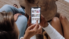 
  Two persons using the Tiktok app on a mobile phone
