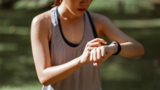 A runner checking on their smartwatch