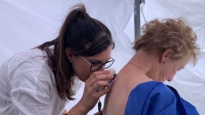 A doctor assessing a patient's skin