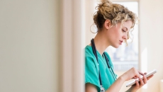 A nurse checking on tasks in their device
