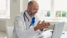 
  A doctor conducting a virtual consultation with a patient using a laptop
