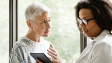 An elderly patient consulting with their doctor