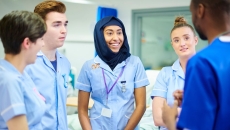 Medical students chatting with their manager during a break after doing their rounds