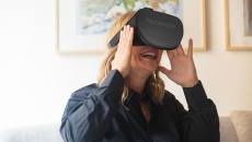 A person uses an AppliedVR-branded virtual reality headset