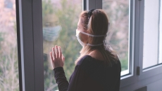 Person looking outside longingly
