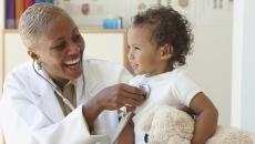 Doctor listens to baby's heart