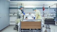 Doctors with patient in hispital bed
