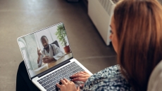 Person on a laptop speaking with a healthcare professional