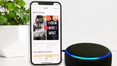 A smartphone displaying the Nurx app next to an Amazon Echo device
