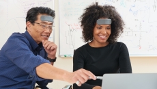 Two people wearing humm "learnable" patch working on a project