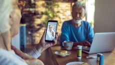 An older couple talking to a doctor via telehealth