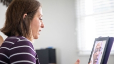 A woman talking to a provider via telehealth