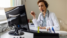 A doctor speaking to a patient on a video call.