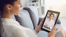 A woman talking to a provider using her tablet.