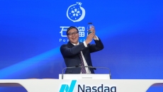 Zhenyang Shi, chairman and CEO of PomDoctor, rings the opening bell following their company's Nasdaq debut