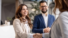 Businesswomen shaking hands during a meeting with a businessman