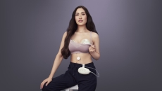 New parent wearing Elvie Stride in their bra posed on a black background