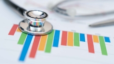 Stethoscope on a colorful financial report