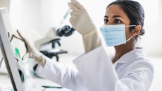 Scientist analyzing contents of test tube