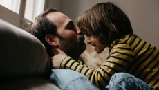 Father and son on a couch playing