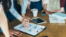 people looking at tablet, papers