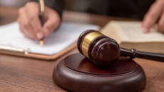 Judge signing a document in a courtroom