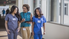 Three healthcare professionals conversing