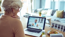 A person talking to a doctor via video call on her laptop.