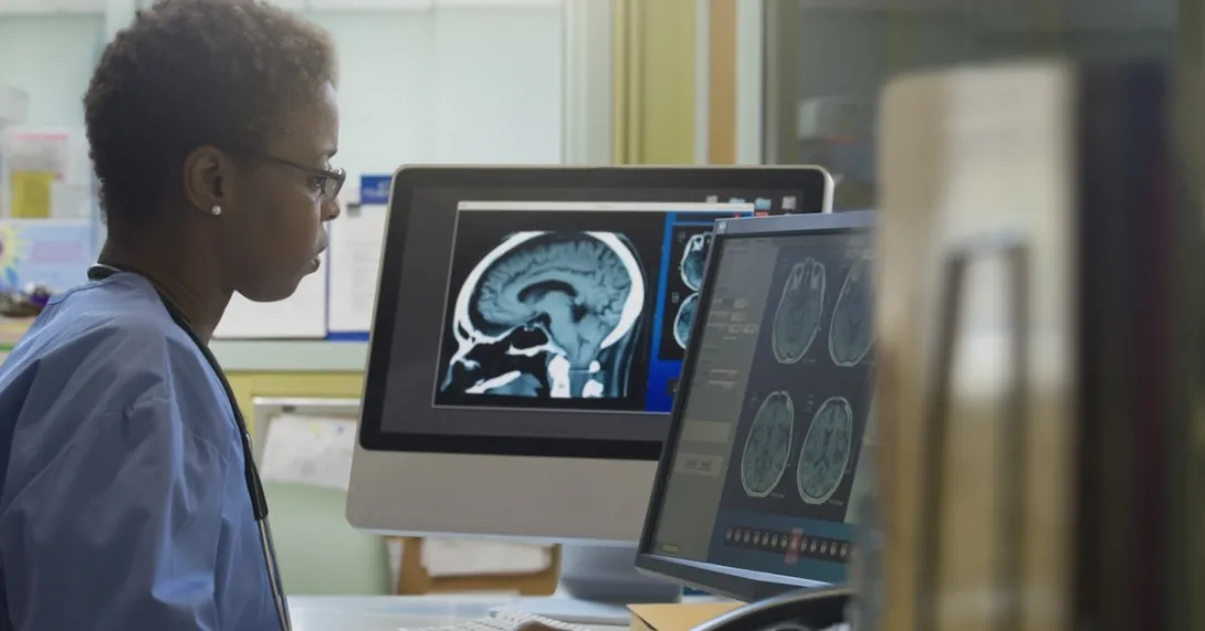 Healthcare professional reviewing imaging on a screen Healthcare professional reviewing imaging on a screen