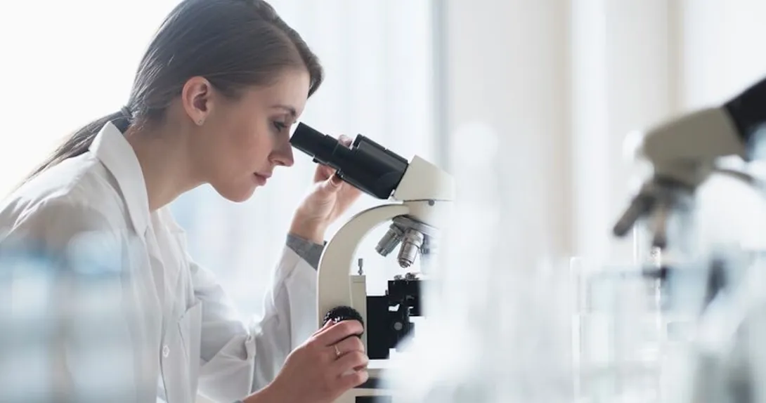 Clinician looking through a microscope Clinician looking through a microscope