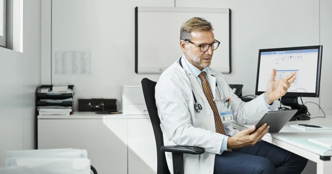 Healthcare practitioners consulting with person on mobile device Healthcare practitioners consulting with person on mobile device