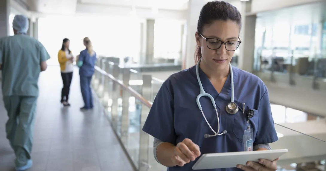 Healthcare professional looking at a tablet
Healthcare professional looking at a tablet