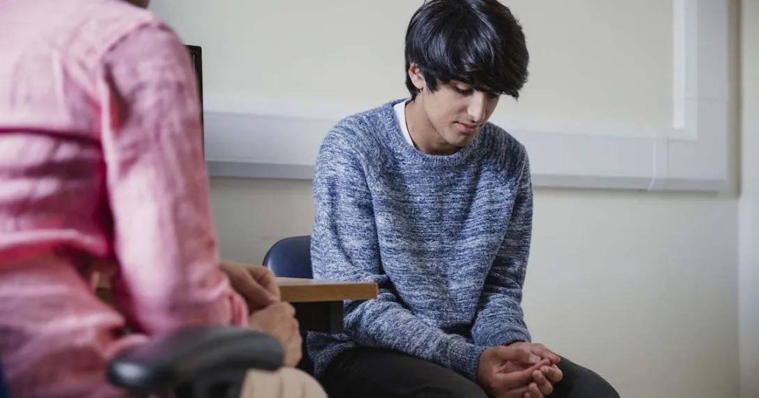 Two people sitting in a room
Two people sitting in a room